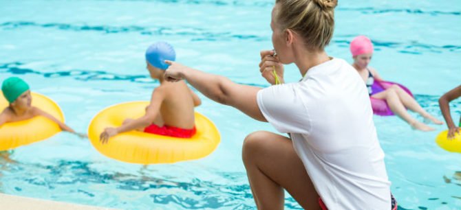 lifeguard watching over a pool to prevent accidents